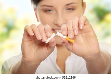 Young woman breaking cigarette over white background - Powered by Shutterstock