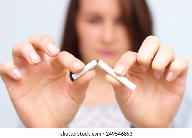 Young woman is breaking a cigarette, quit smoking concept - Powered by Shutterstock