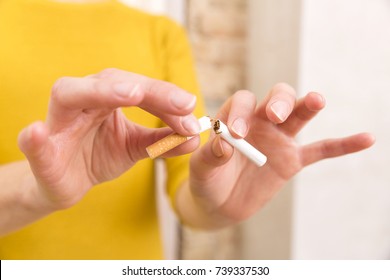 Young woman is breaking a cigarette, quit smoking concept - Powered by Shutterstock