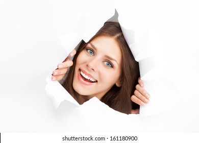 Young Woman Breaking Through A Paper Sheet.