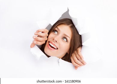 Young Woman Breaking Through A Paper Sheet.