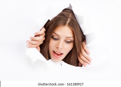 Young Woman Breaking Through A Paper Sheet.