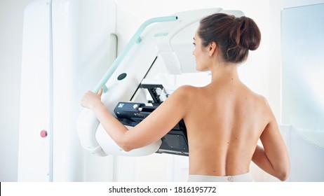 Young woman at breast cancer prevention screening at hospital. Hardware examination of the breast. Healthy young woman doing cancer prophylactic mammography scan. Modern hospital with hi-tech machine - Shutterstock ID 1816195772