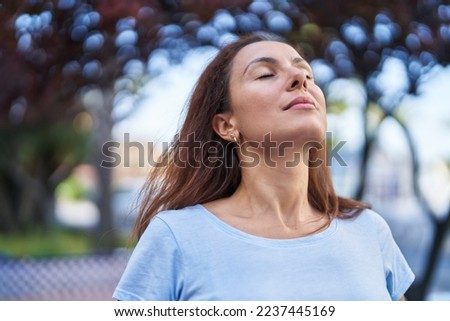 Young woman breathing at park