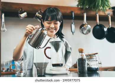 A Young Woman Brewing Coffee In A Relaxing Space