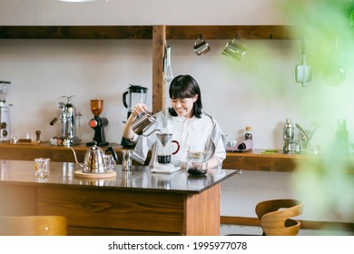 A Young Woman Brewing Coffee In A Relaxing Space