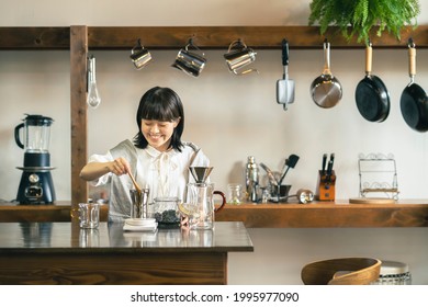 A Young Woman Brewing Coffee In A Relaxing Space