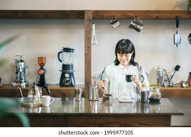 A Young Woman Brewing Coffee In A Relaxing Space