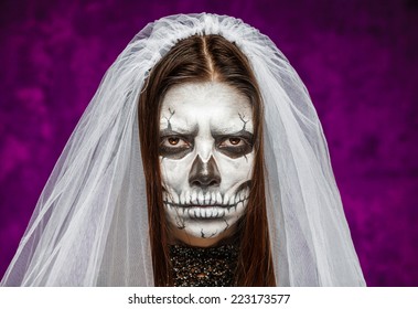 Young Woman A Bride In A Veil On The Day Of The Dead Mask Skull Face Art. Halloween Face Art.