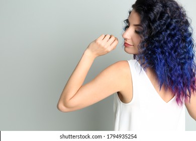 Young woman and bright dyed hair grey background  back view  Space for text