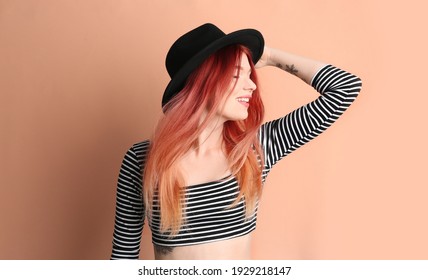 Young woman and bright dyed hair pale pink background