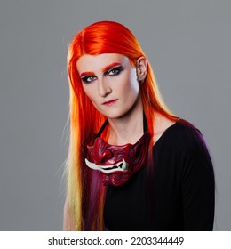 Young Woman With Bright Orange Hair In Asian Demon Mask, Futuristic Cyber Punk Style, Close-up