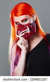 Young Woman With Bright Orange Hair In Asian Demon Mask, Futuristic Cyber Punk Style, Close-up