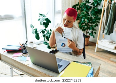 A young woman with bright pink hair focuses on her creative project at home, surrounded by plants. - Powered by Shutterstock