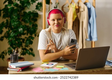 A young woman with bright pink hair works on creative projects while enjoying her home environment. - Powered by Shutterstock