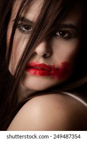 Young Woman With Bright Red Lipstick Smudged.