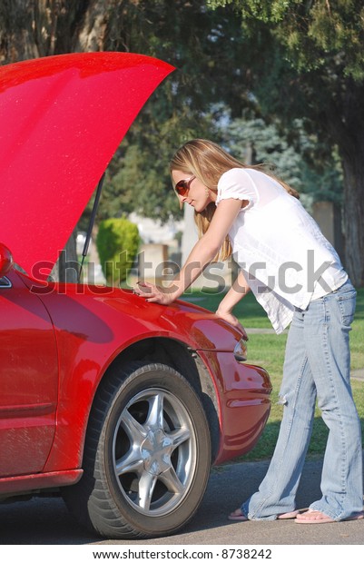 Young Woman with Broken Down\
Car