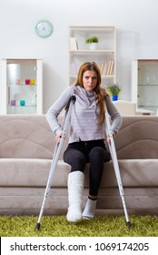 Young Woman With Broken Leg At Home