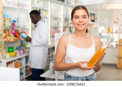 Young Woman With Brown Hair Electing Haircare Shampoo In Drugstore