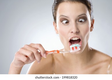 Young Woman Brushing Her Teeth, Smiling, Close Up