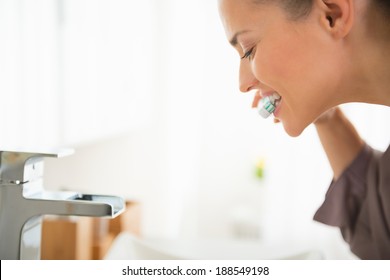 Young Woman Brushing Teeth