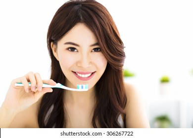 Young Woman  Brushing Teeth In The Morning