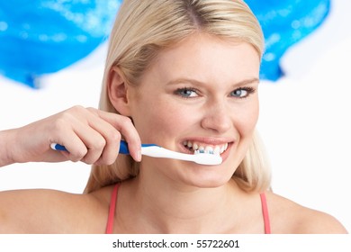 Young Woman Brushing Teeth In Studio