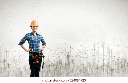 Young Woman Builder In Hardhat Wearing Toolbelt