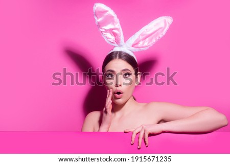 Young woman with bunny ears. Thinking surprised. Funny emotions, excited expressing