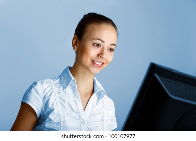 Young woman in business wear in headset working with computer - Shutterstock ID 100107977