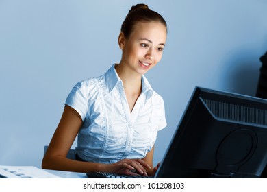 Young woman in business wear in headset working with computer - Shutterstock ID 101208103