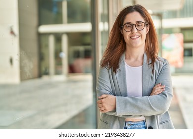 Young woman business worker standing with arms crossed gesture at street - Shutterstock ID 2193438277
