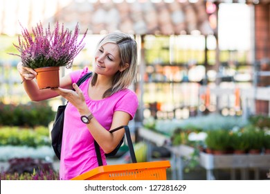 Young Woman Buying Flowers At A Garden Center