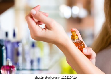 Young Woman Buying Perfume In A Shop Or Store, Testing The Fragrance On The Skin