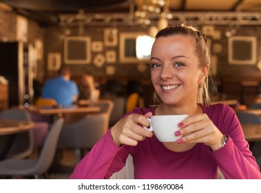 Young woman in a cafe drinking coffee, beautiful smiling. - Shutterstock ID 1198690084