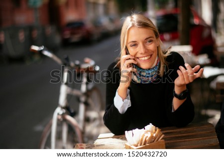 Young woman in cafe talking on phone