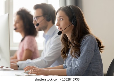 Young woman call center agent operator telemarketer in wireless headset talking consulting online client using computer working in customer service support helpline helpdesk telesales office