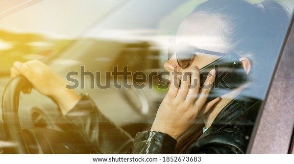 Young\
woman calling by mobile while driving a car, dangerous phone\
calling while driving a car, transport\
concept
