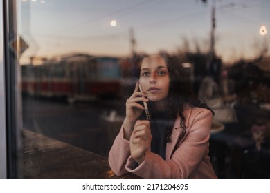 Young Woman Calling And Enjoying Her Leisure Time Alone In Cafe