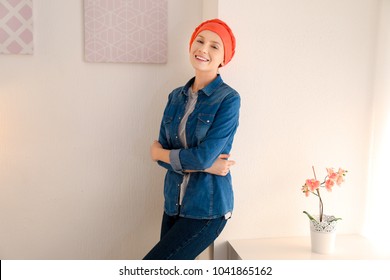 Young Woman With Cancer In Headscarf Indoors