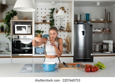 Young Woman Cancer Survivor Cooking And Preparing Vegetarian Meal After Long Heavy Sickness. Vegan Female In The Kitchen Making Healthy Lunch From Fresh Vegetables Changing Way Of Life After Illness.