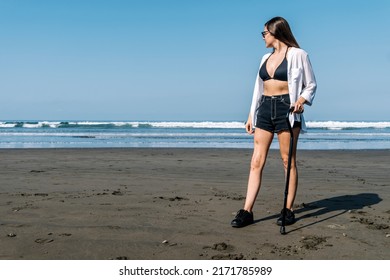 Young Woman With Cane Looking At The Sea. Cancer Survivor.
