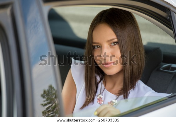 Young Woman in Car on\
Backseat