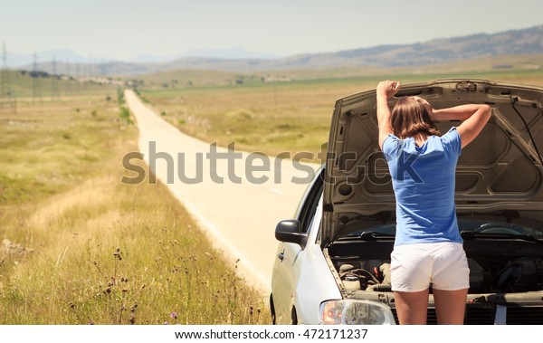Young woman with car\
problem on the road
