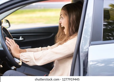 Young woman in car. Ride instruction accident. Automobile loan.