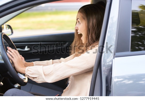 Young woman in car. Ride instruction accident.\
Automobile loan.
