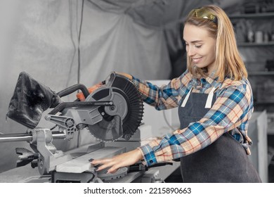 Young Woman Carpenter Using Power Tools For Her Work In Woodshop. Concept Disregard For Safety, How Not To Do.