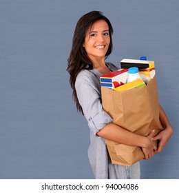 Young Woman Carrying Bag Of Grocery