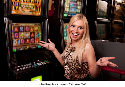 Young woman in Casino on a slot machine