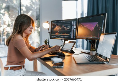 Young Woman In Casual Clothes Is In Office With Multiple Screens.